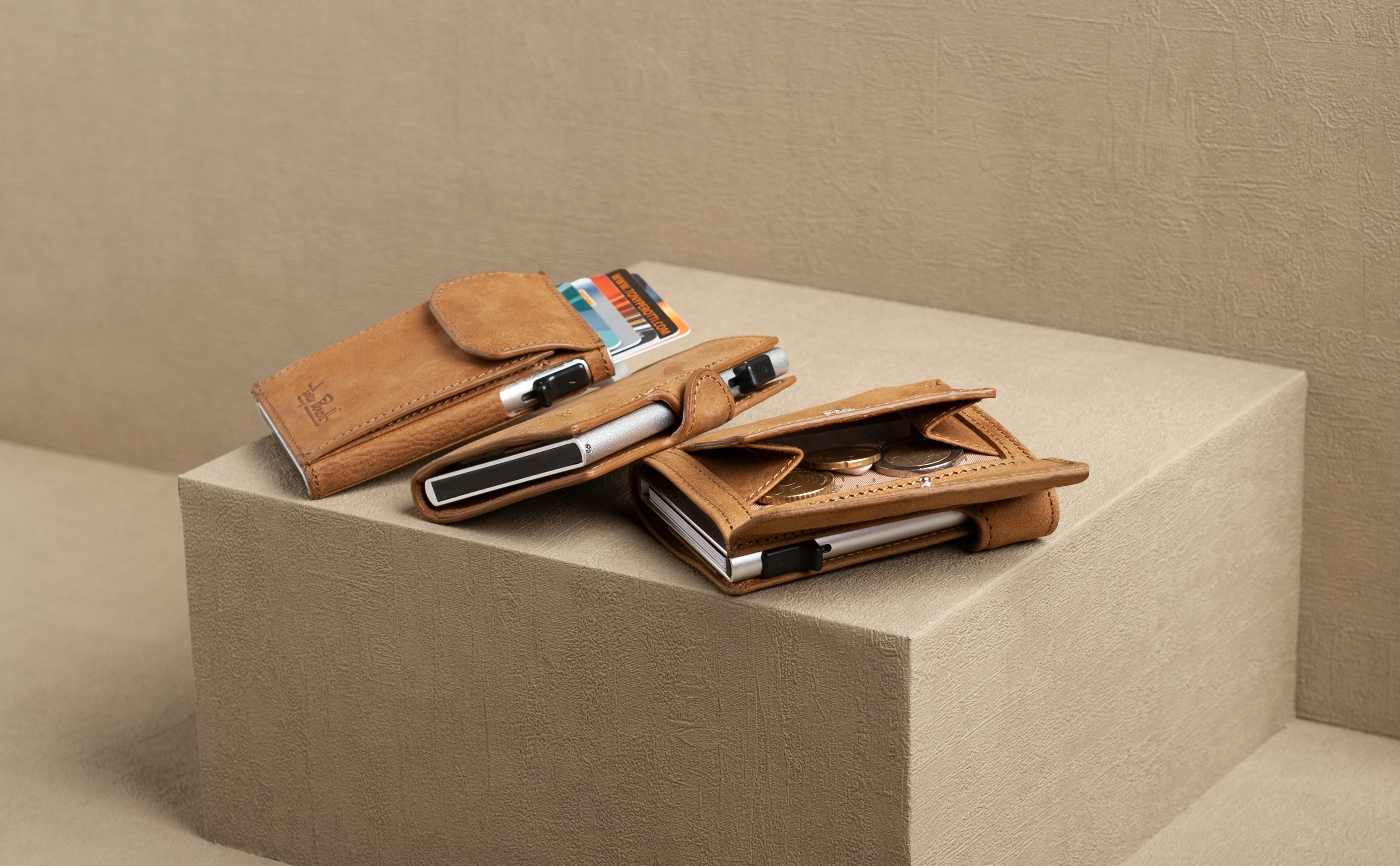 Brown leather wallet with multiple card slots on a beige surface