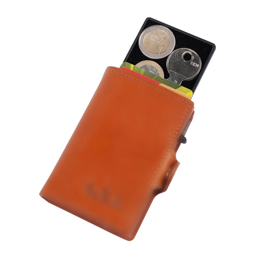Tony Perotti black aluminium tray for Furbo, sliding out of a Cognac Furbo card holder with coins and a key inside